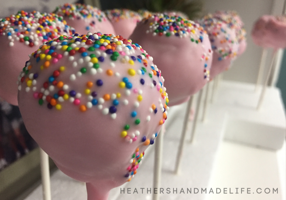 pink cake pops with rainbow sprinkles