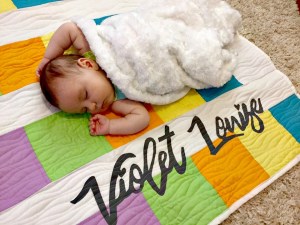 Rainbow quilt with appliqued baby name {Heather's Handmade Life}